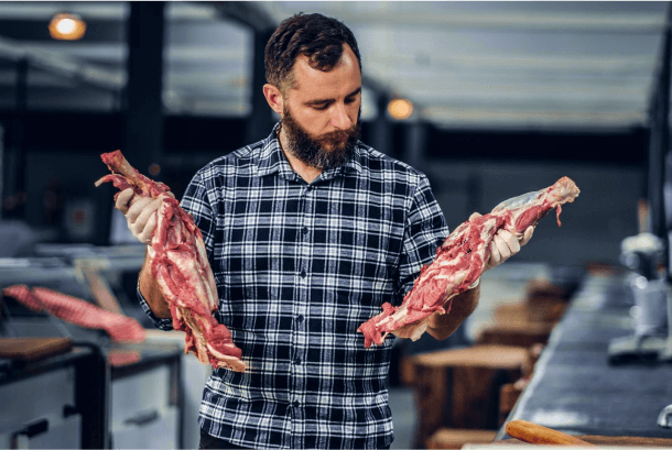 Man holding premium cuts of Wagyu beef.