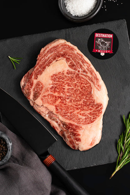Miyazaki A5 wagyu ribeye steak with intense marbling BMS 11 on dark slate board