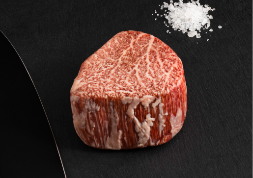 Raw beef piece seasoned with salt.