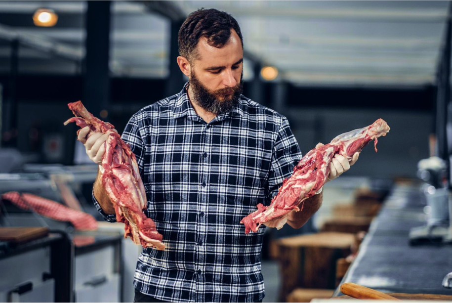 Man holding premium cuts of Wagyu beef.