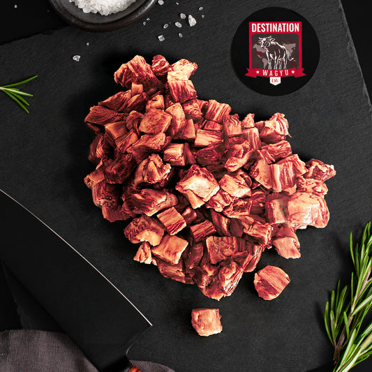 Japanese A5 wagyu stir fry on a slate grey board and knife with destination wagyu logo