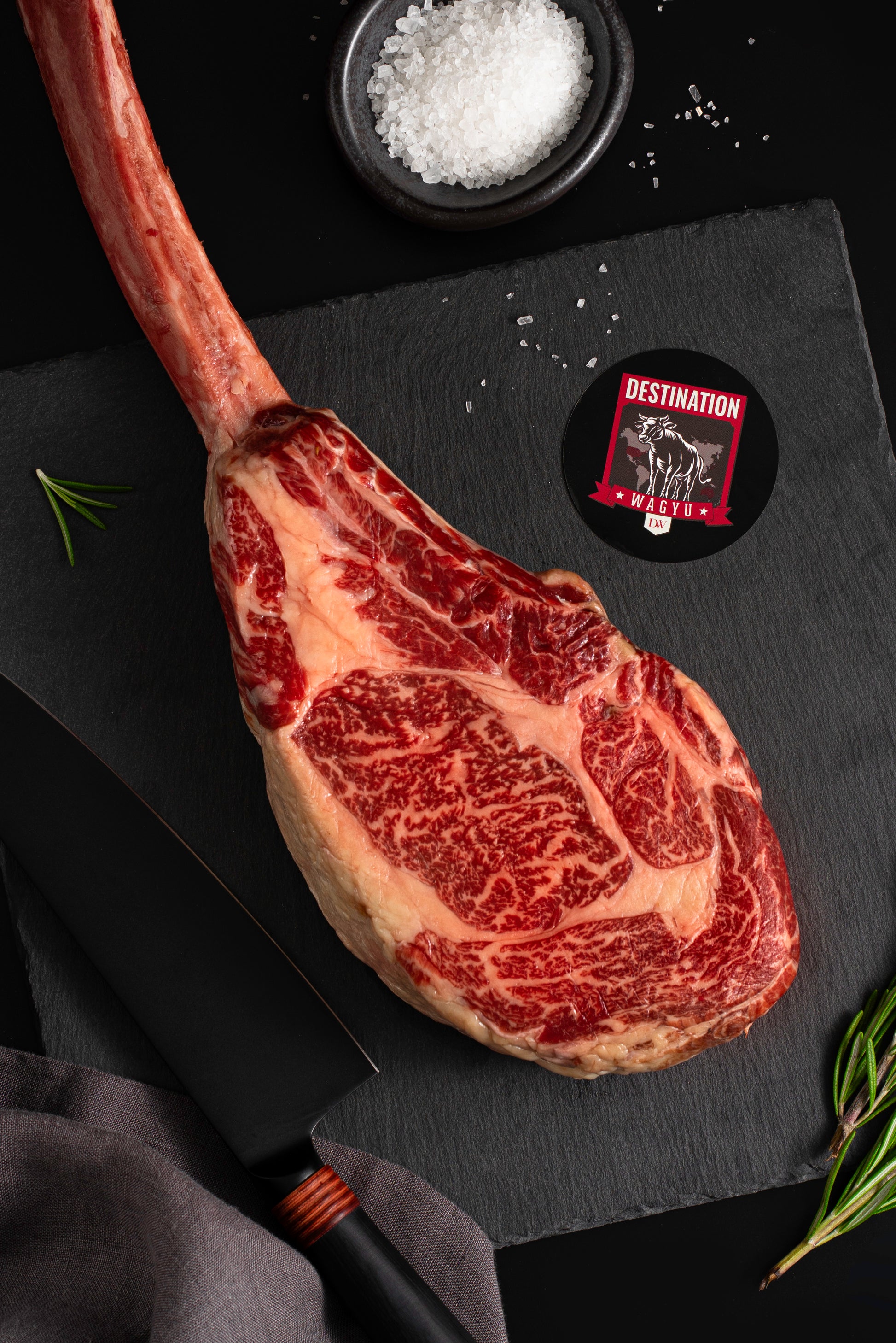 An Australian wagyu tomahawk steak on a black board 