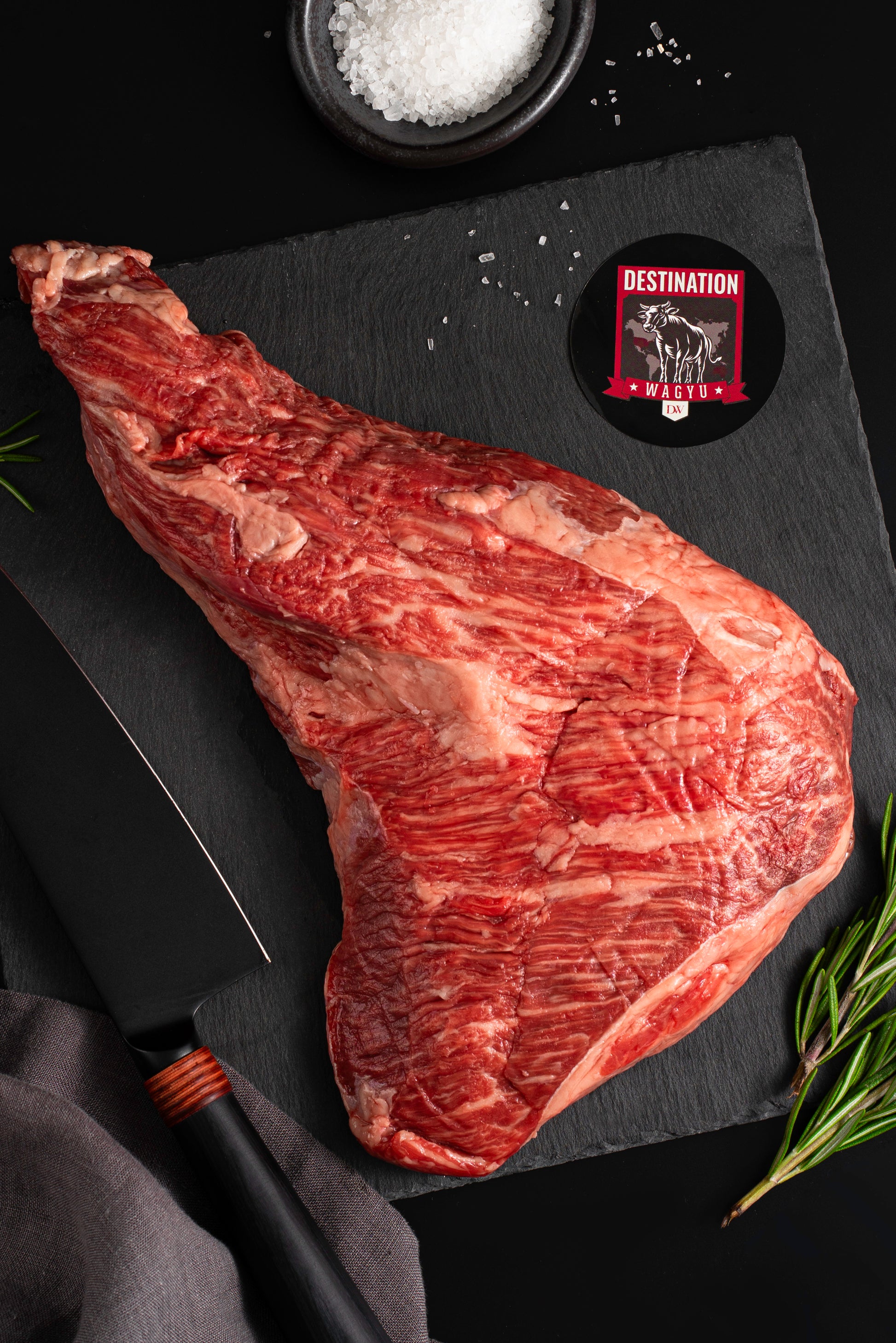 American wagyu tri tip steak on a black board 