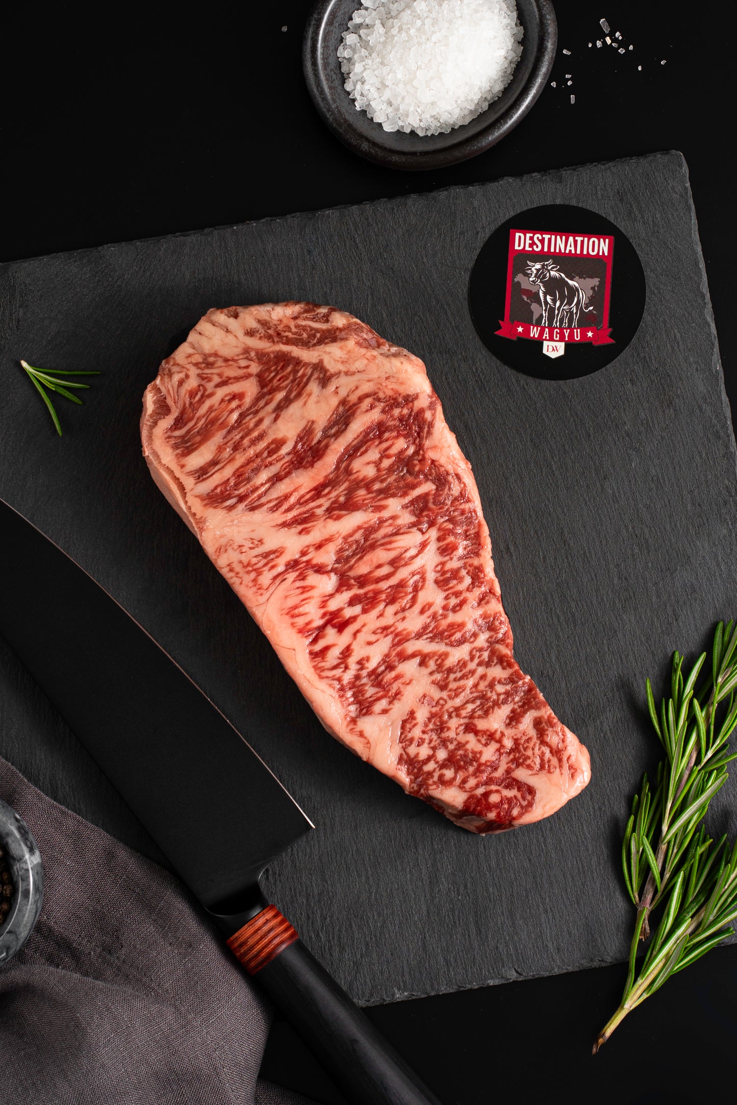 An Australian wagyu full blood striploin steak on a black board 