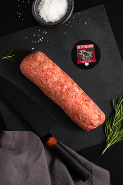 Japanese a5 wagyu ground beef in 16oz size on a slate black board with knife and sa