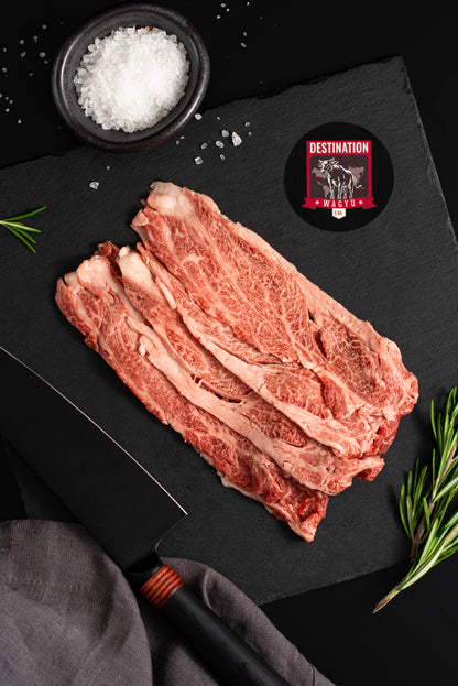 Japanese a5 wagyu shabu shabu on a black board with a knife and salt