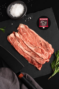 Japanese a5 wagyu shabu shabu on a black board with a knife and salt